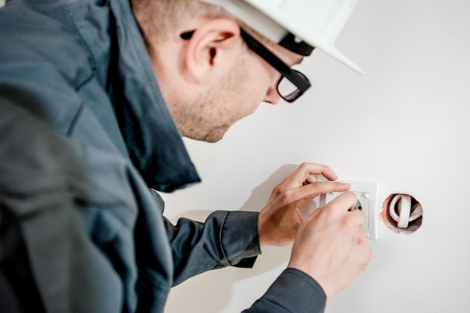 Electrician installing a wall socket